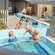2 women and 2 young girls lounging in and around the shallow waters of an outdoor whirlpool spa